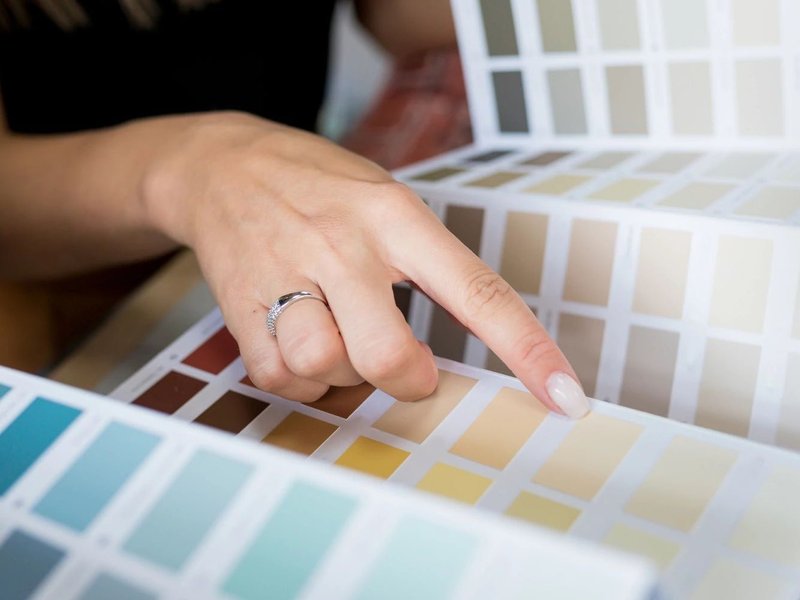 woman choosing from color palette - Main Street Carpets and Flooring in Texas City, TX